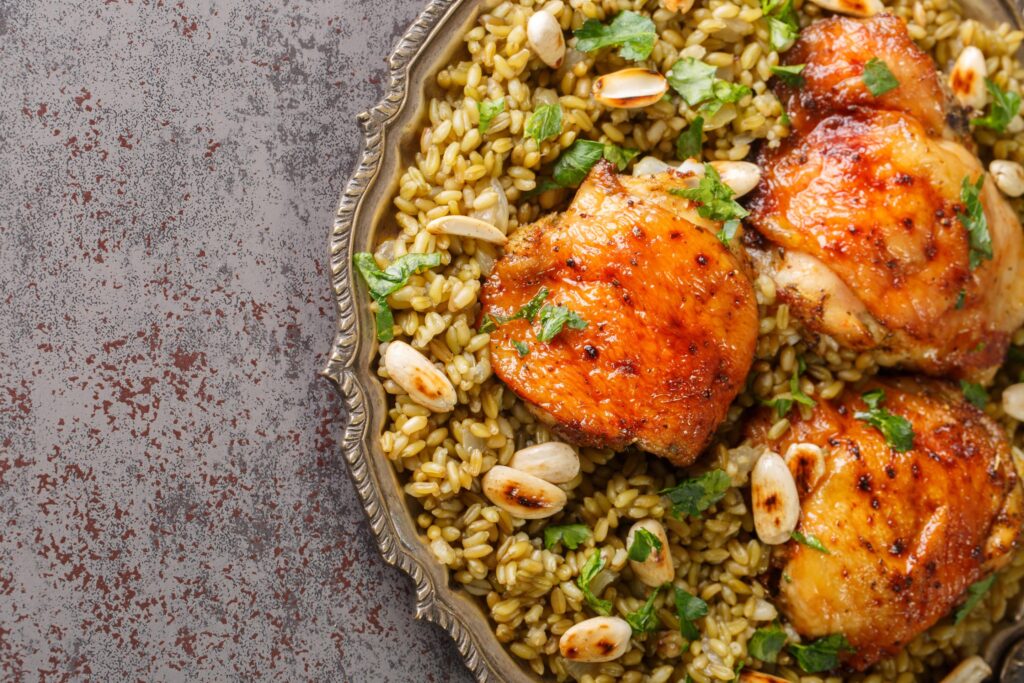 a bowl of freekeh prepared with chicken and herbs